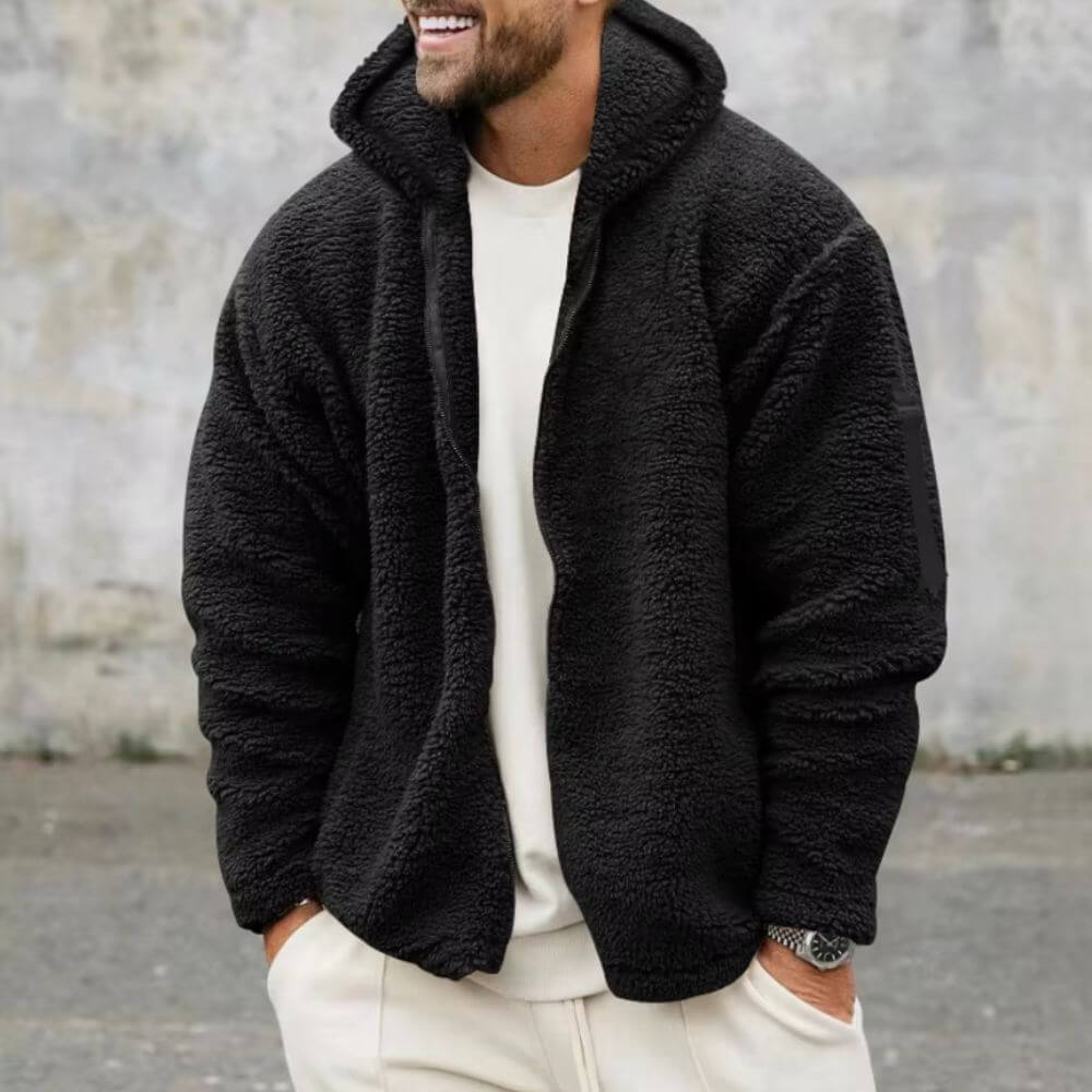 Warme schwarze Teddy-Fleece-Jacke mit weicher Textur.